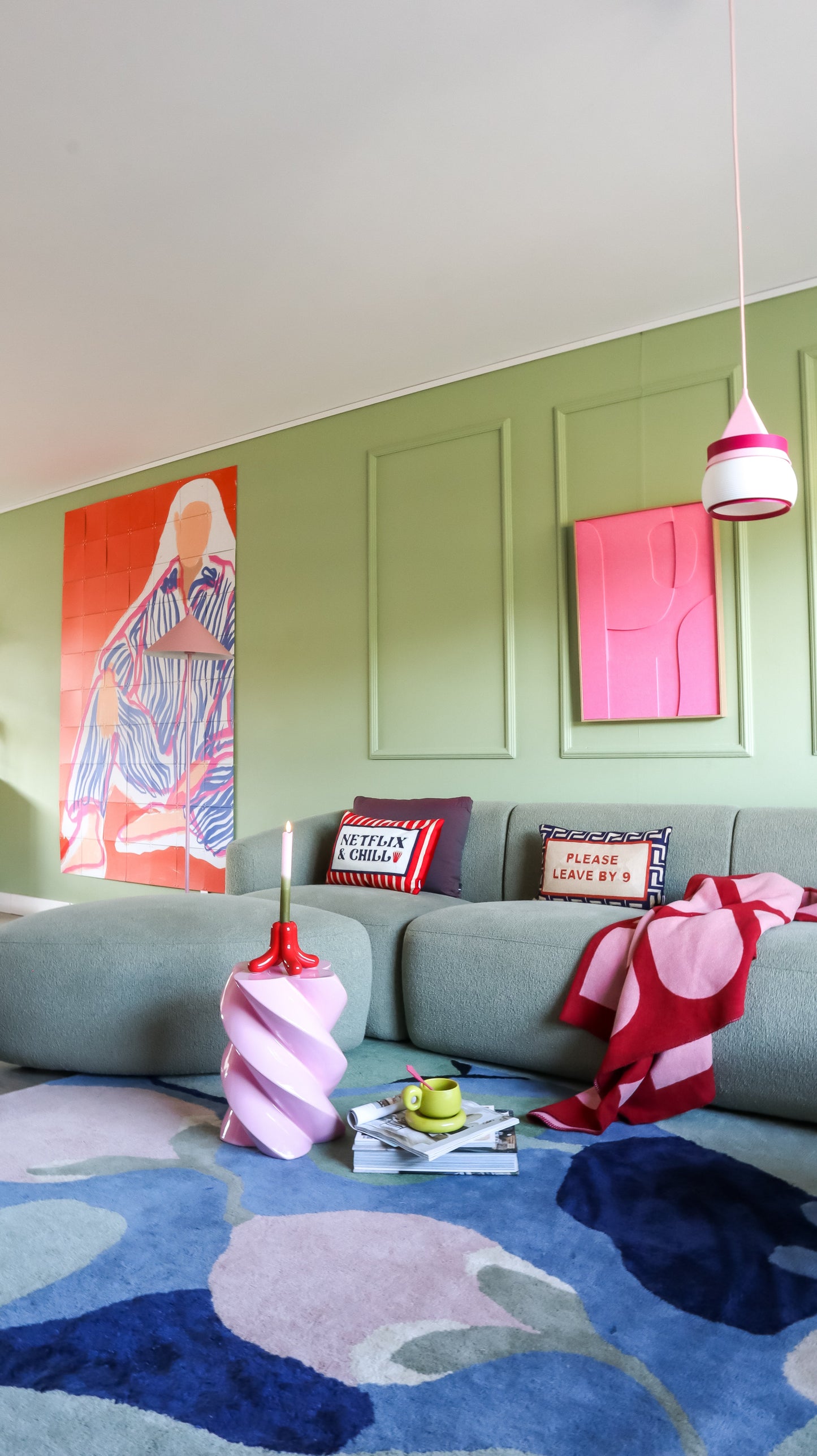 Living room with a gray sofa, colorful rug, and decorative pillows. | Extraordinary Emporium