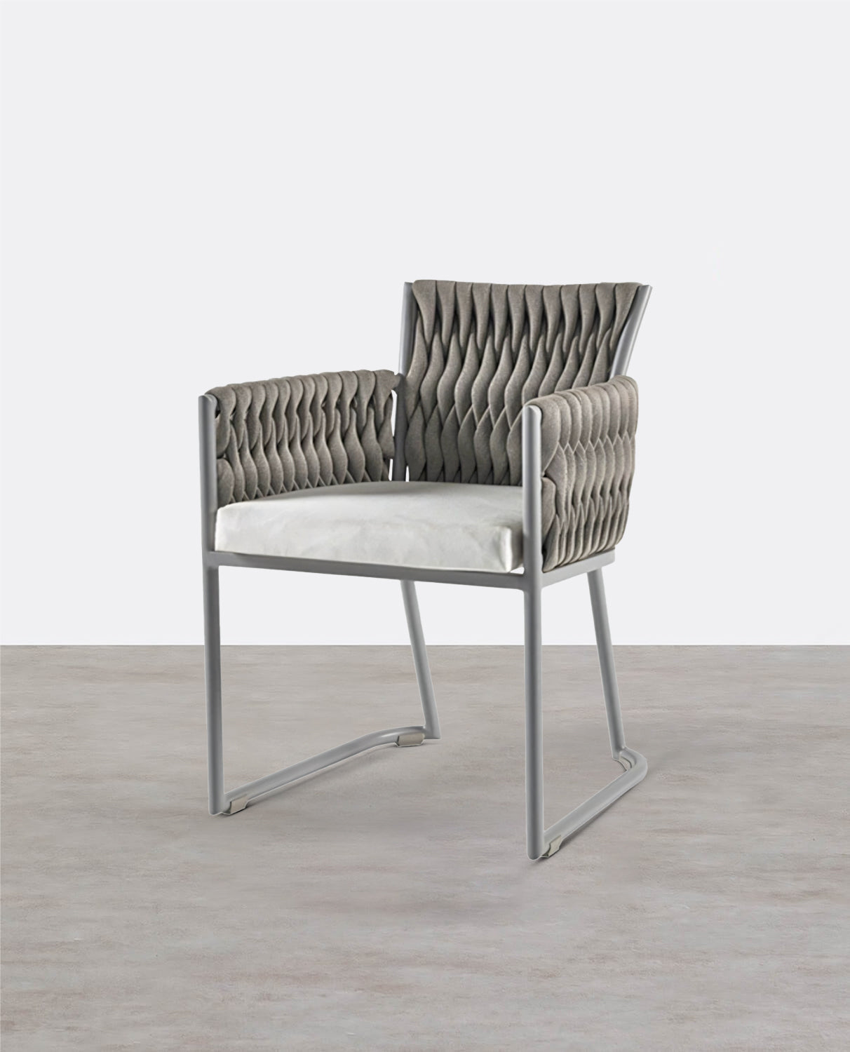 Modern chair with quilted backrest and white cushion on a light wooden floor. 