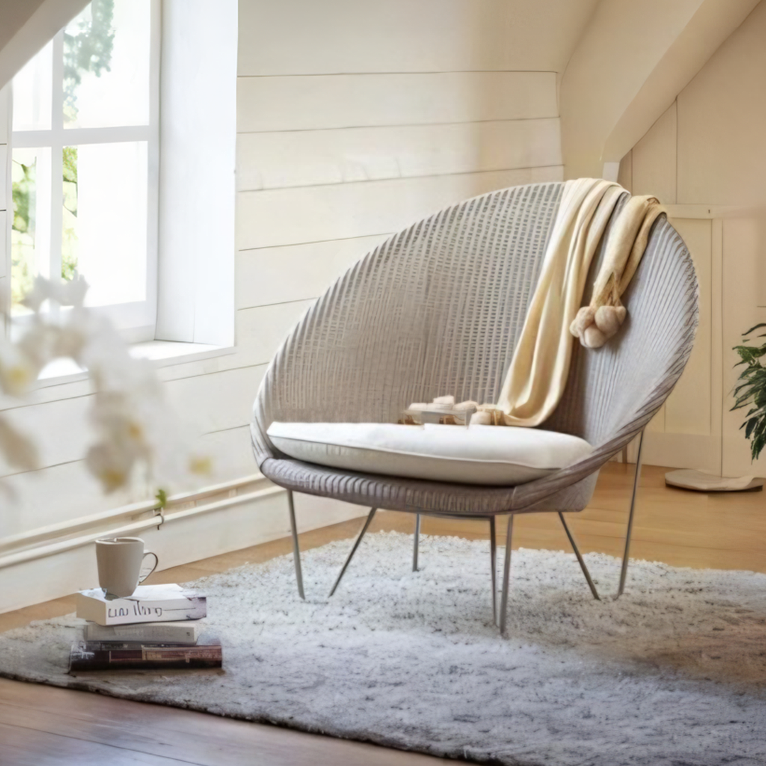Wicker chair with a blanket in a bright room with large windows  | Extraordinary Emporium UK