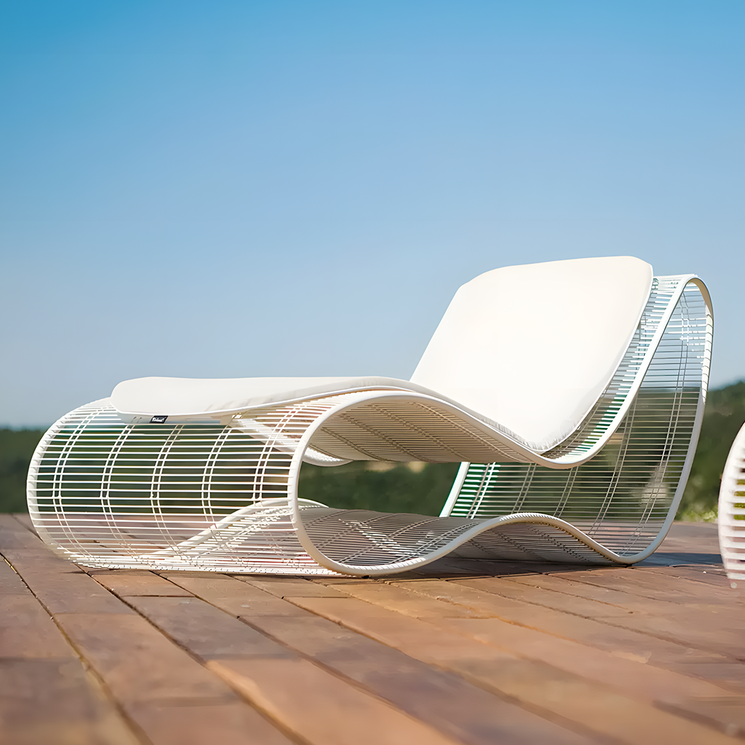 Modern white lounge chair on a wooden deck with a clear blue sky background | Extraordinary Emporium 