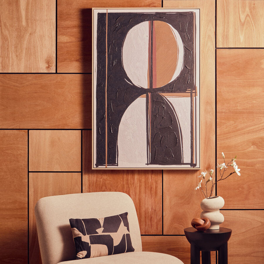 Abstract art piece on a wooden wall with a chair and decorative items | Extraordinary Emporium