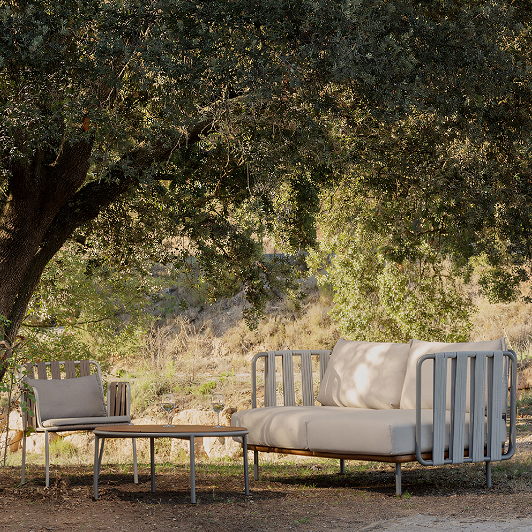 Outdoor patio set with a sofa and chairs under a tree  | Extraordinary Emporium UK