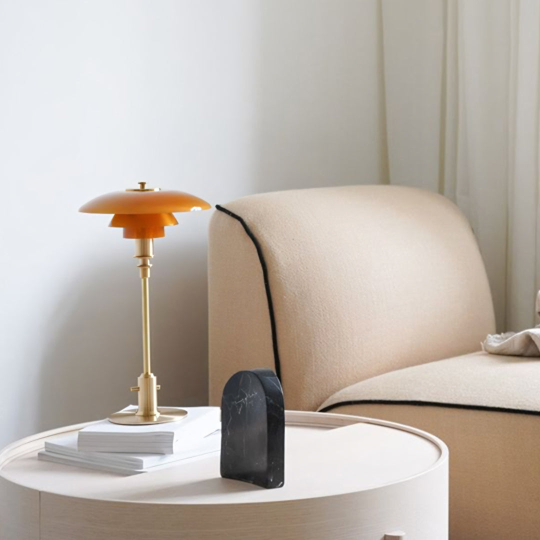 Modern interior with a beige sofa, white side table, and orange lamp.  | Extraordinary Emporium UK