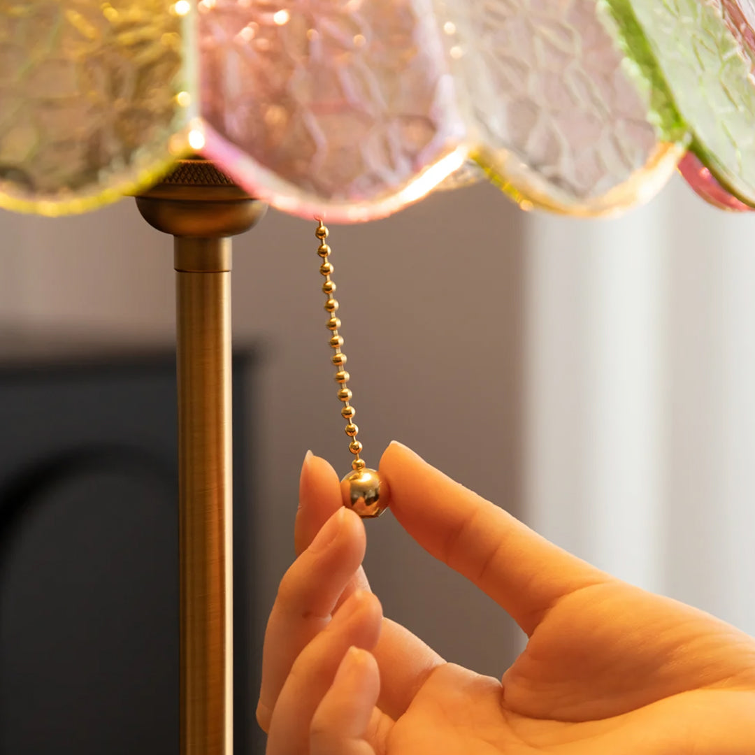 Hand adjusting a pull chain on a lamp  | Extraordinary Emporium UK
