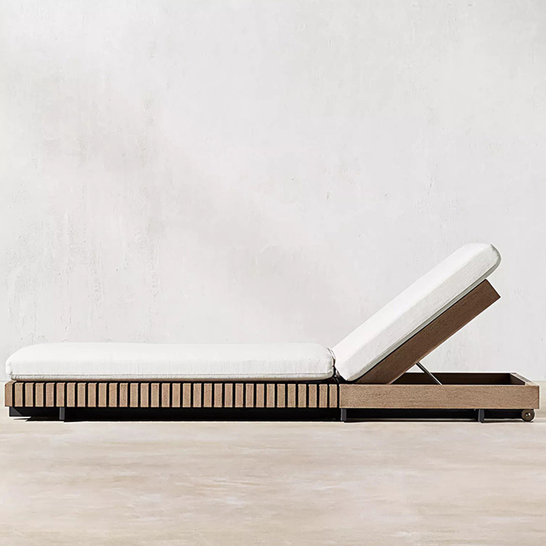 Modern outdoor lounge chair with white cushion on a light wooden floor against a white wall.  | Extraordinary Emporium UK