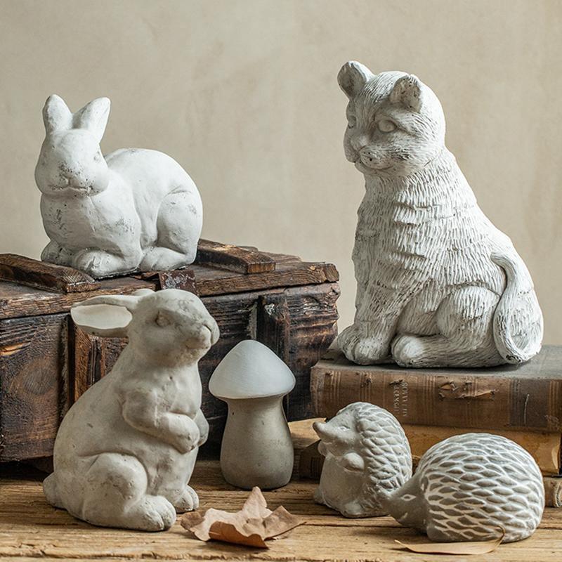 Set of stone animal figurines including a rabbit, cat, mouse, mushroom, hedgehog, and ball on a wooden surface.  | Extraordinary Emporium UK